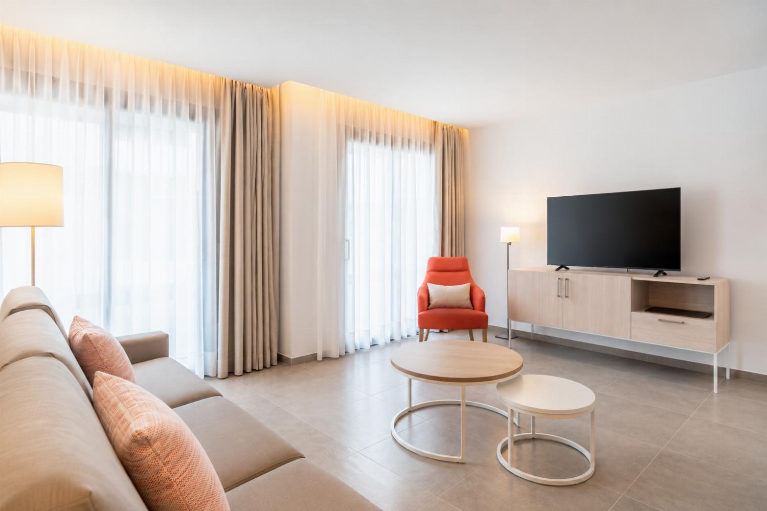 A bright modern open-plan living area with a stylish kitchen, dining space.