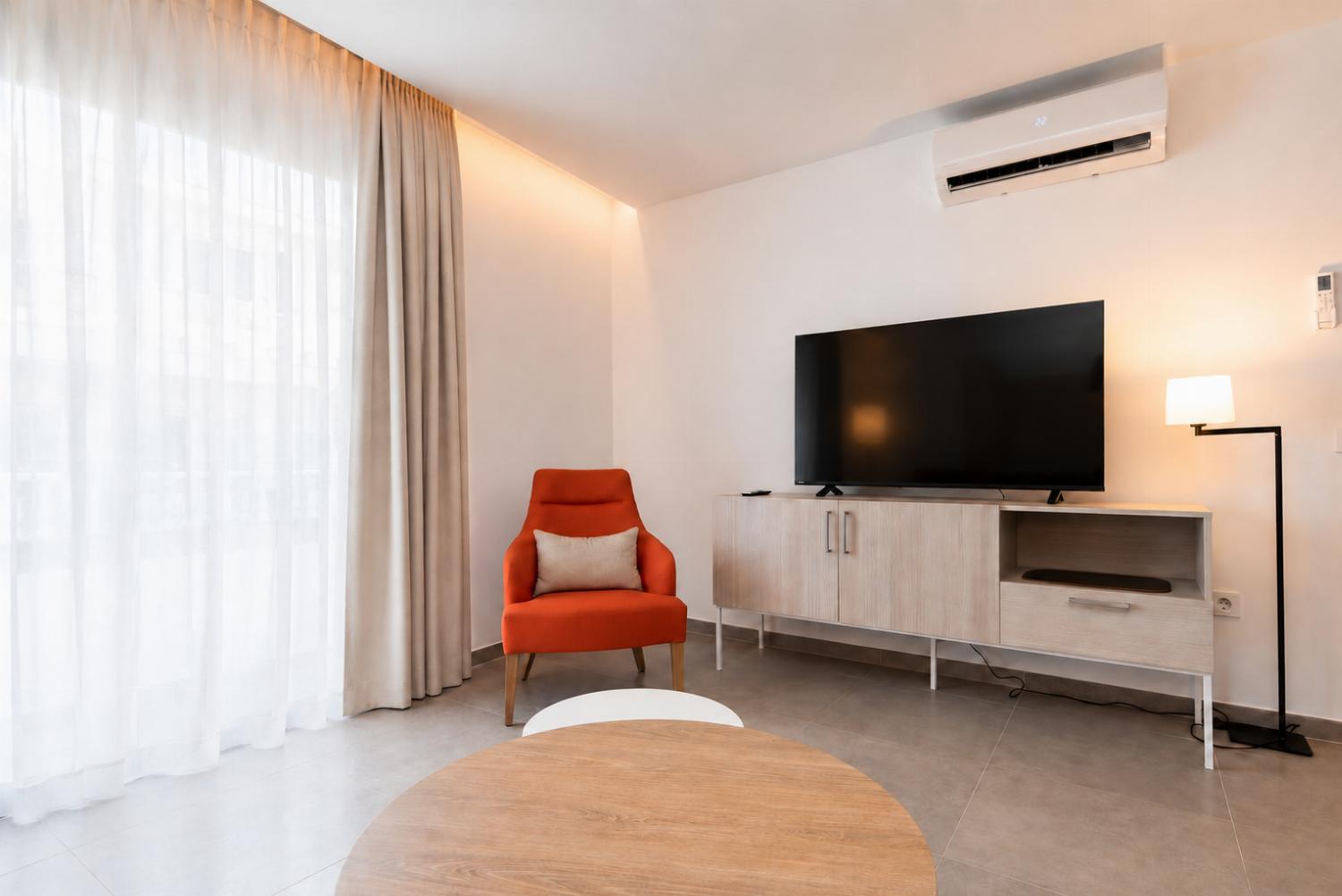 A modern open-plan living and dining area with elegant neutral decor.