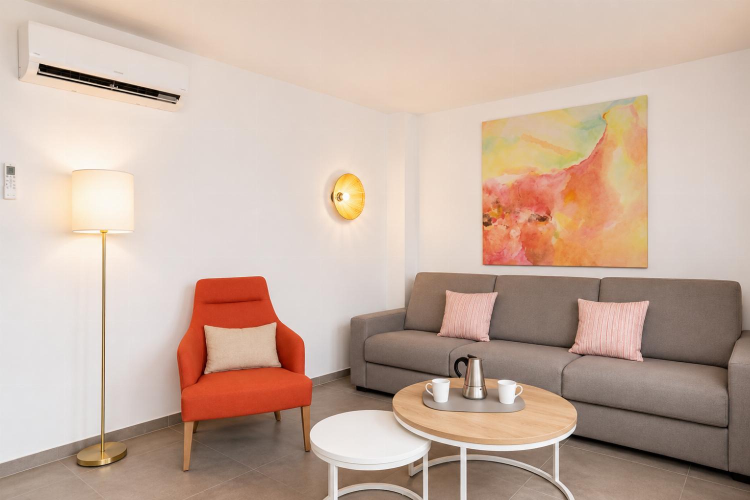 A modern open-plan living and dining area with elegant neutral decor.