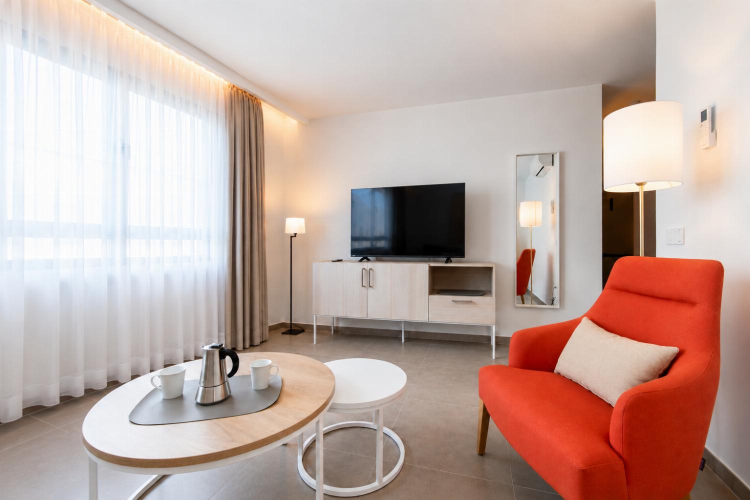 ,A modern open-plan living and dining area with elegant neutral decor.