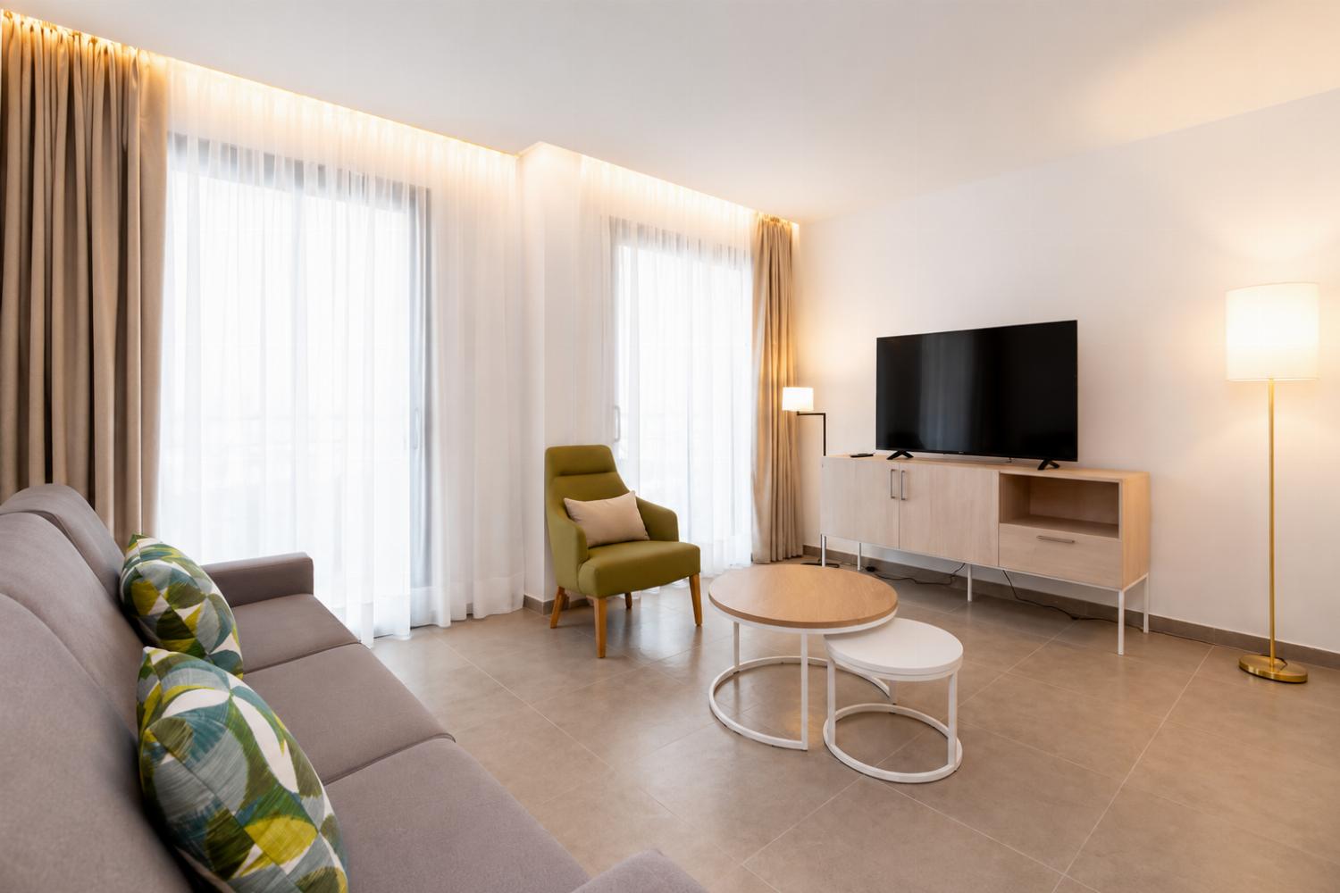 ,A bright modern living room with soft natural light, elegant neutral decor.