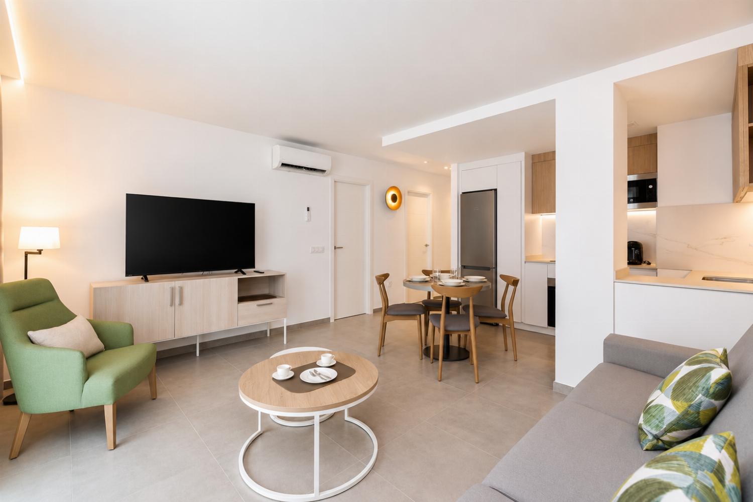 ,A modern open-plan living and dining area with elegant neutral decor.