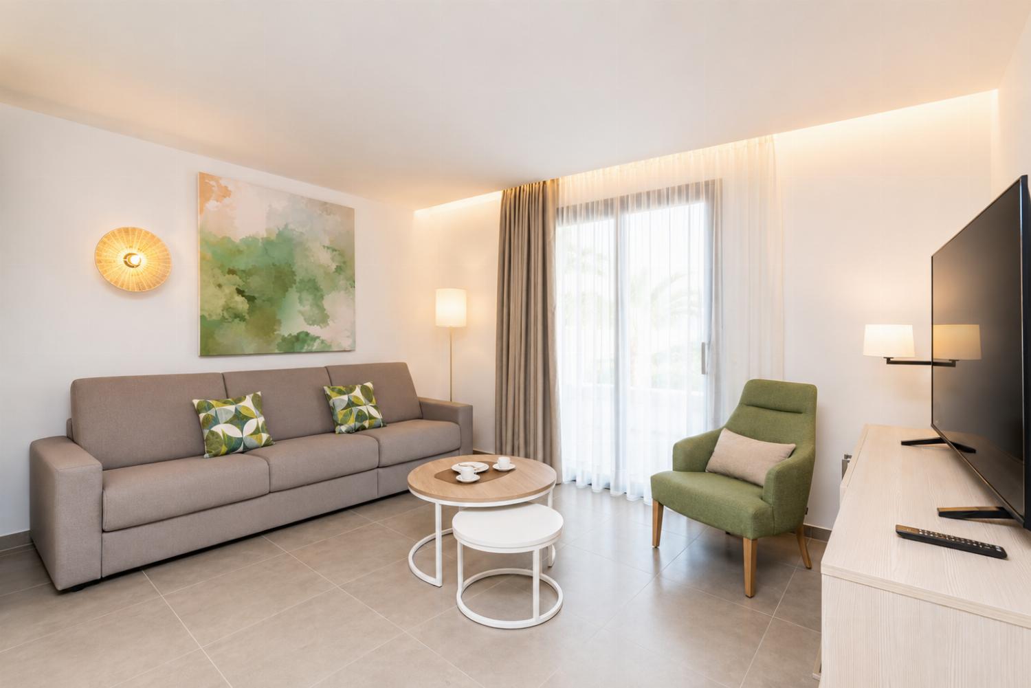 A modern open-plan living and dining area with elegant neutral decor.