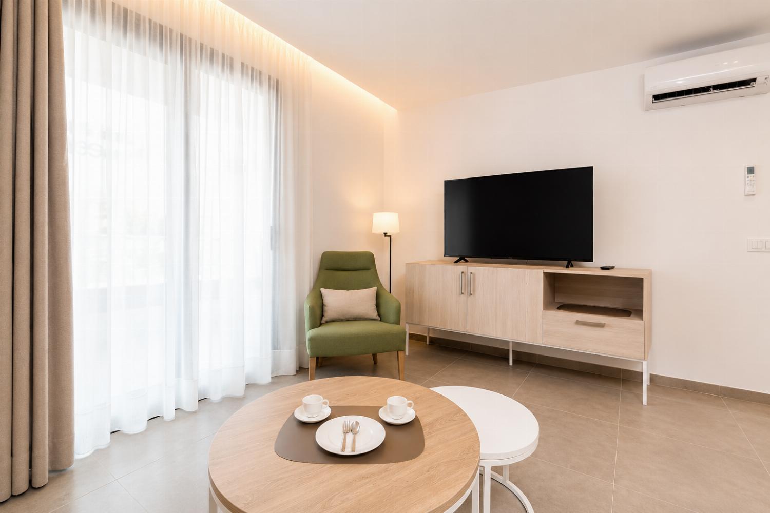 A bright modern living room with soft natural light, elegant neutral decor.