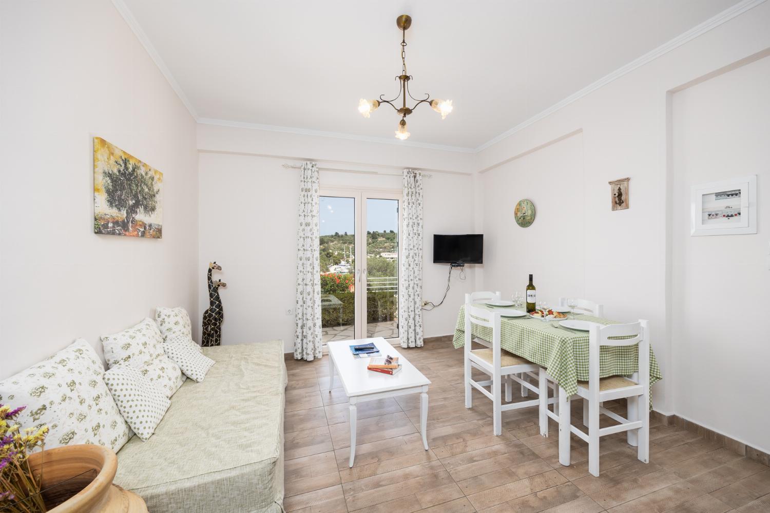 Ground floor: open-plan living room with sofa, dining area, kitchen, WiFi internet, and satellite TV