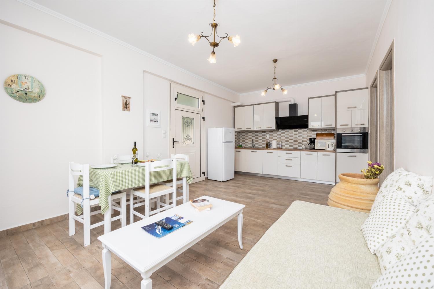 Ground floor: open-plan living room with sofa, dining area, kitchen, WiFi internet, and satellite TV