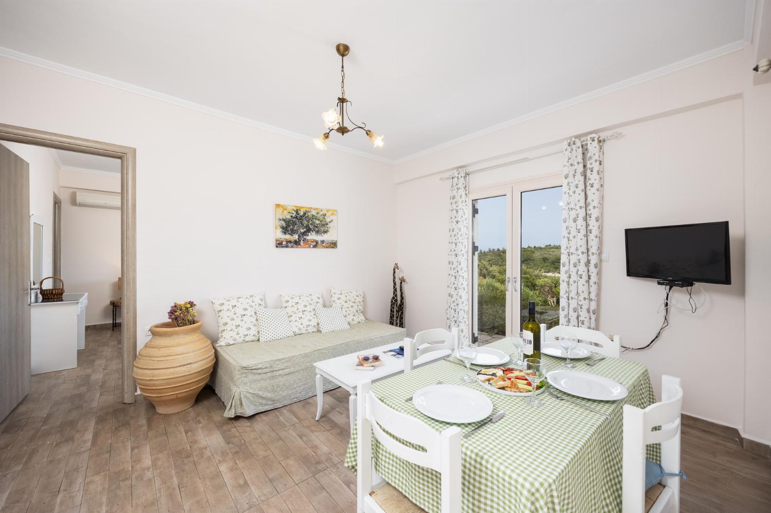Ground floor: open-plan living room with sofa, dining area, kitchen, WiFi internet, and satellite TV
