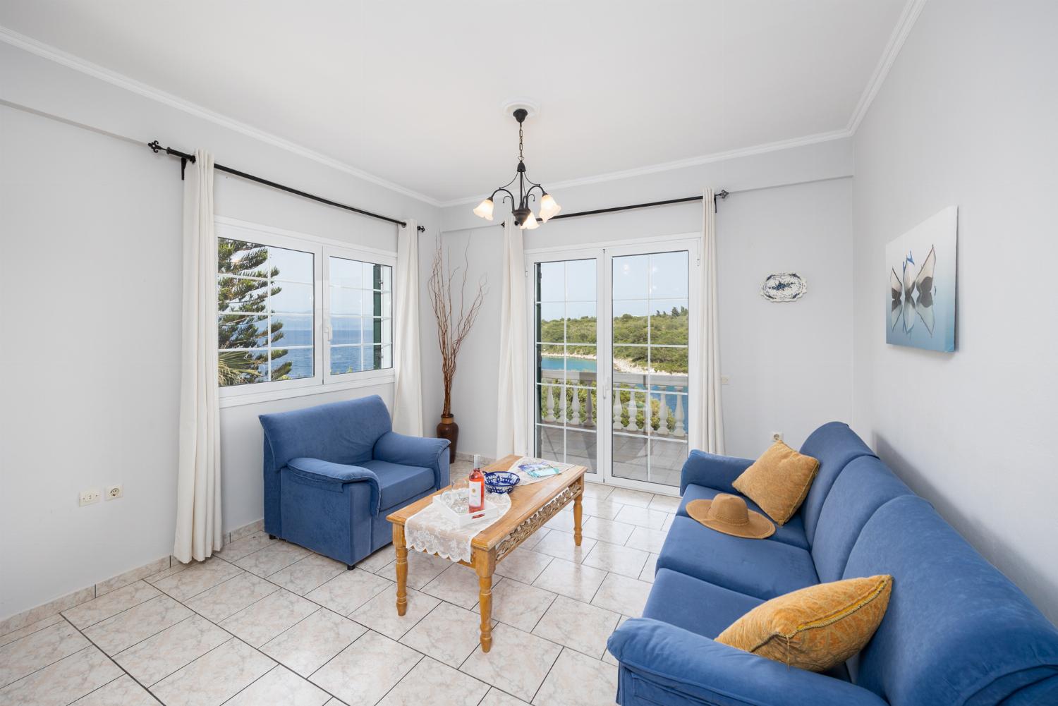 First floor: open-plan living room with sofa, dining area, kitchen, WiFi internet, satellite TV, and sea views