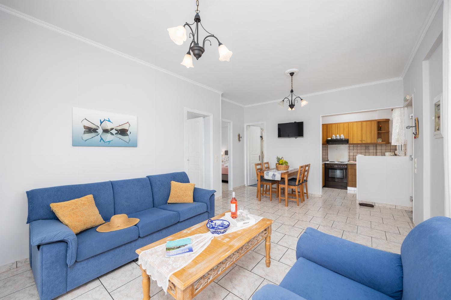 First floor: open-plan living room with sofa, dining area, kitchen, WiFi internet, satellite TV, and sea views