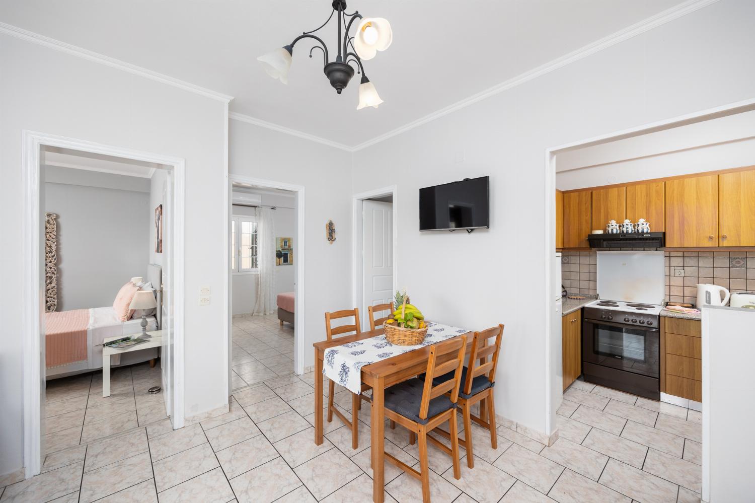 First floor: open-plan living room with sofa, dining area, kitchen, WiFi internet, satellite TV, and sea views