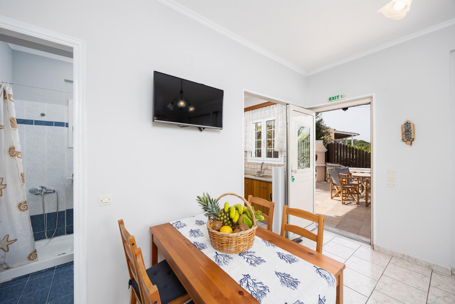 First floor: open-plan living room with sofa, dining area, kitchen, WiFi internet, satellite TV, and sea views