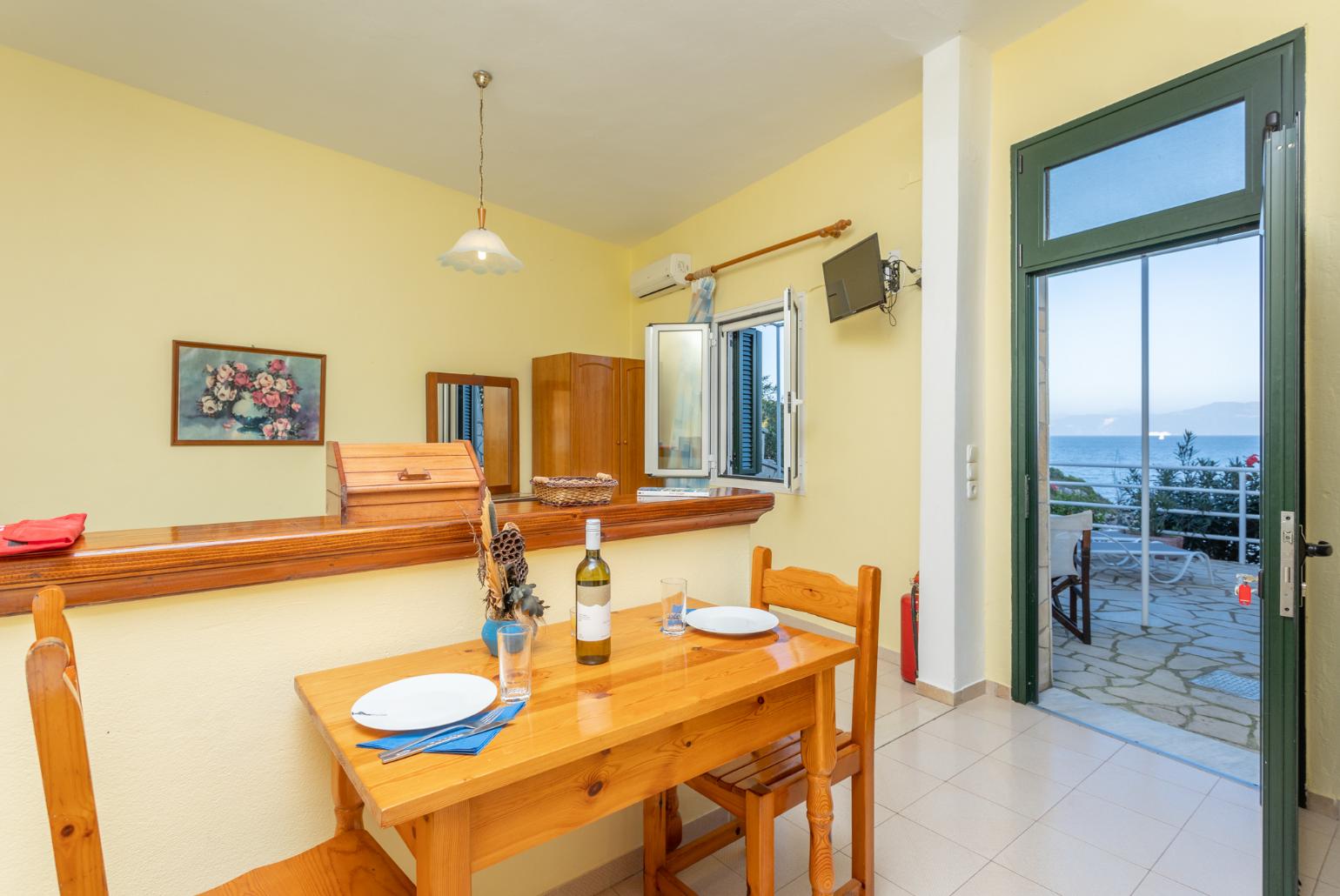 Open-plan studio with twin beds, dining area, kitchen, A/C, WiFi internet, satellite TV, and sea views