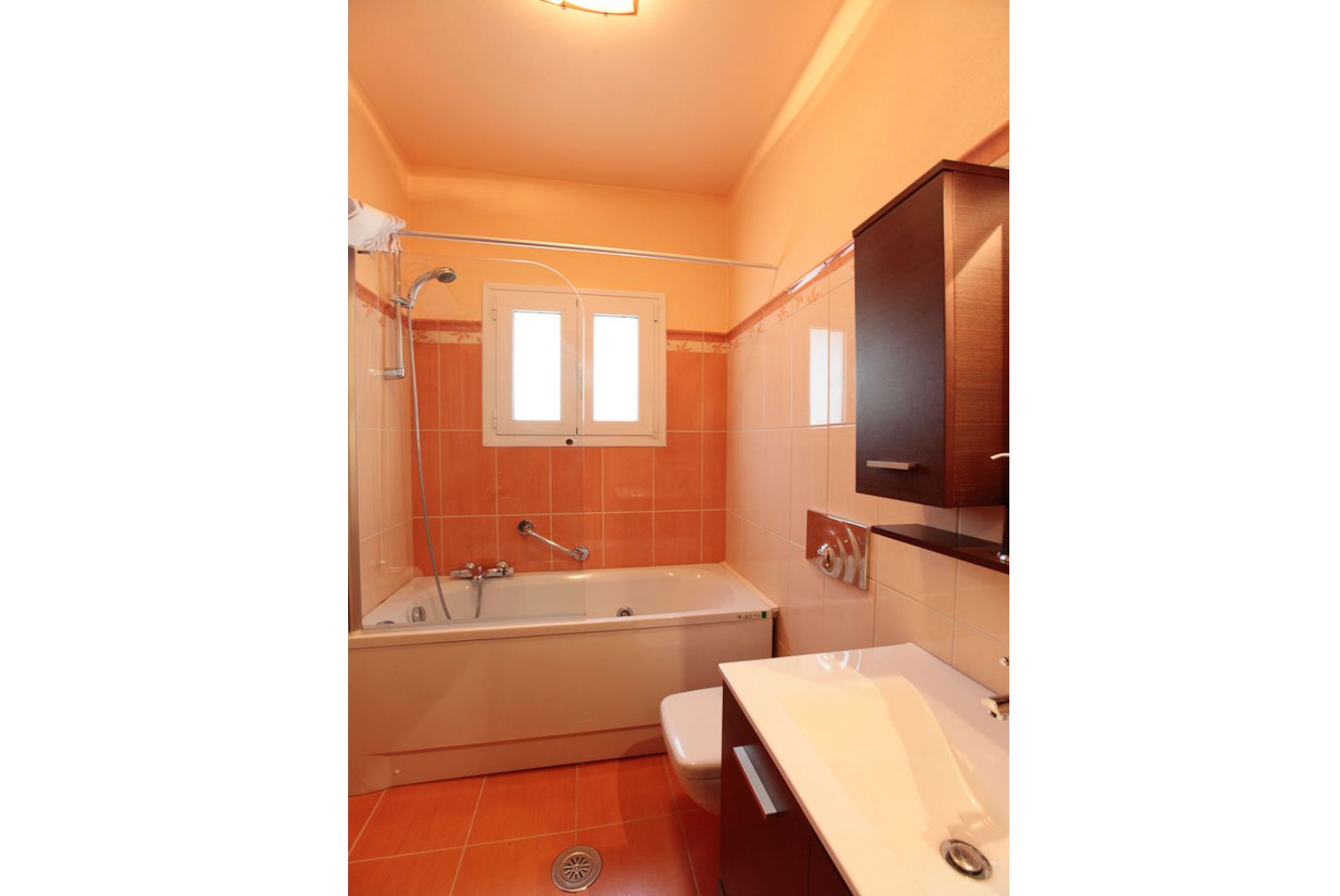 Bathroom with bath and overhead shower
