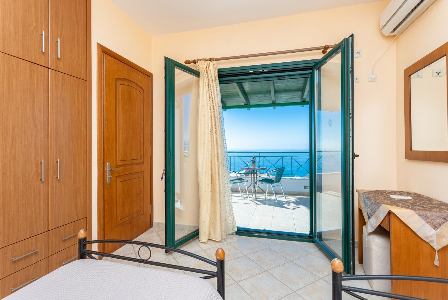 Twin bedroom with en suite bathroom, A/C, sea views, and upper terrace access