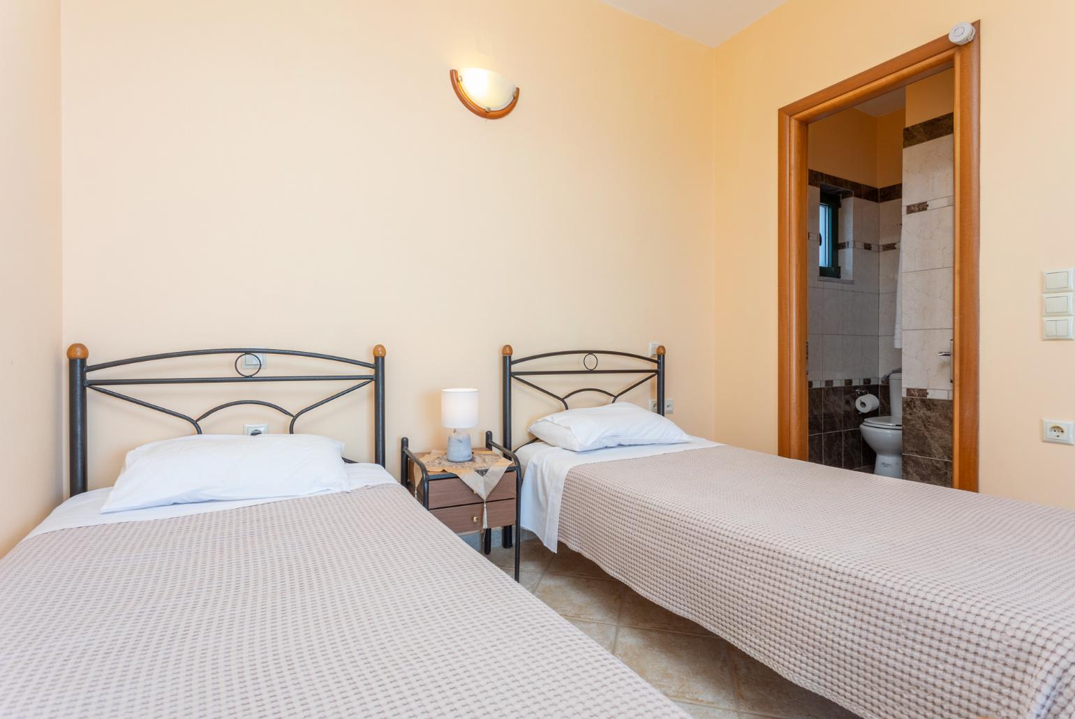 Twin bedroom with en suite bathroom, A/C, sea views, and upper terrace access