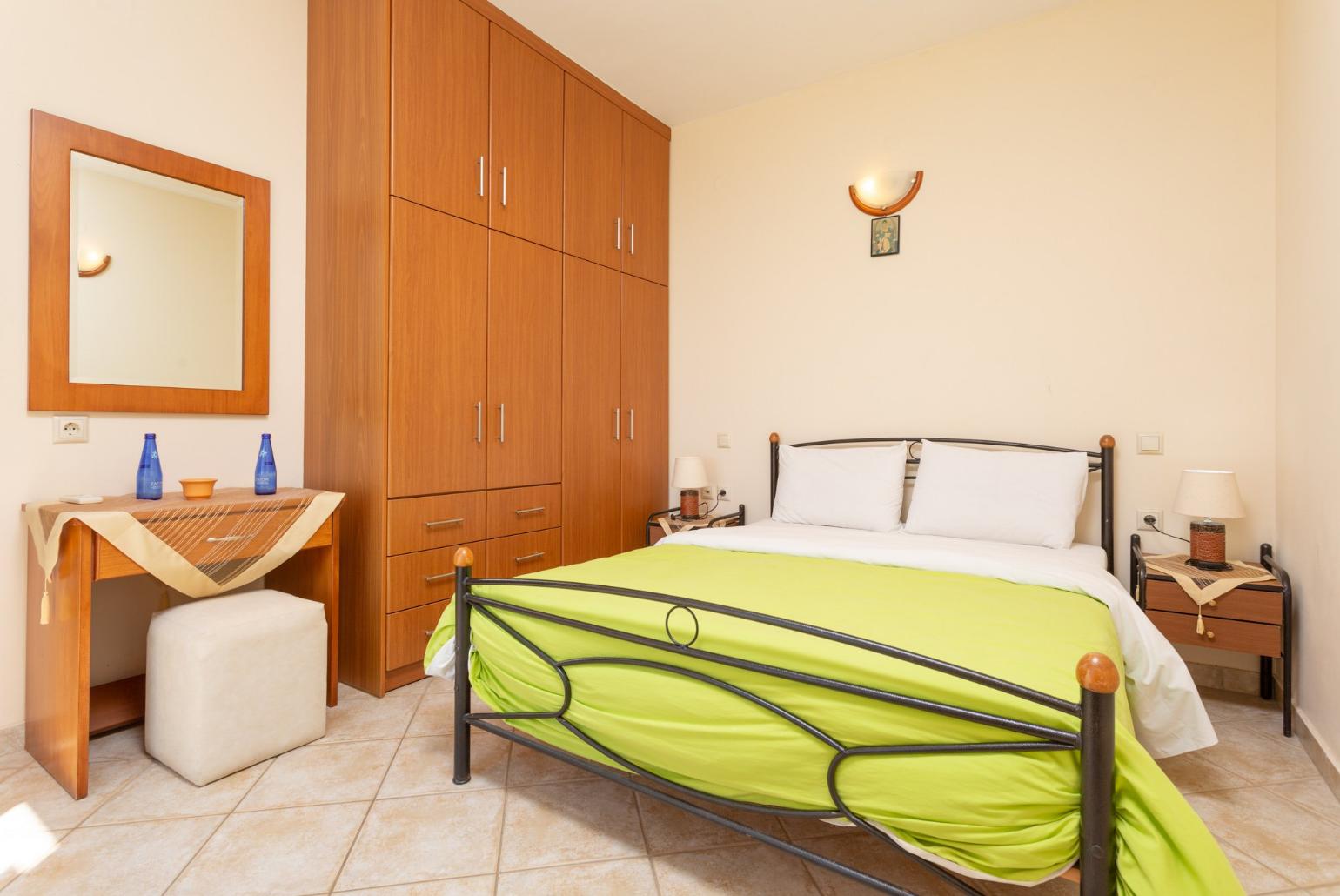Double bedroom on ground floor with en suite bathroom, A/C, and terrace access with sea views