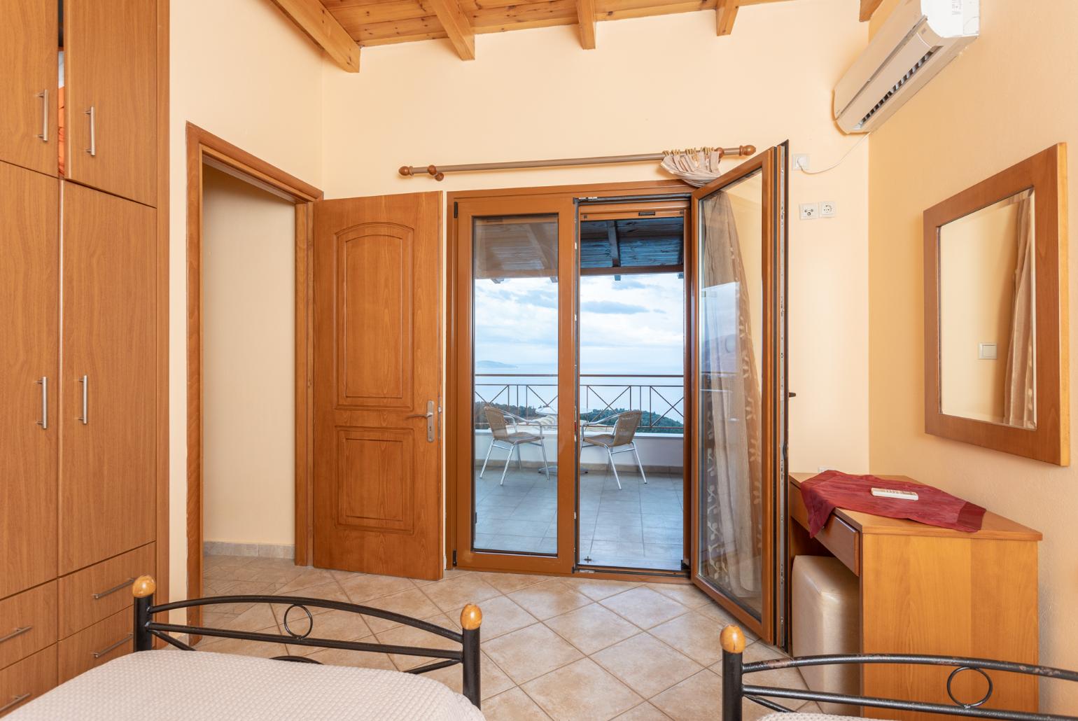 Twin bedroom with en suite bathroom, A/C, sea views, and upper terrace access